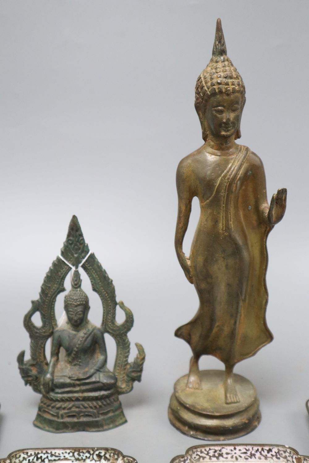 A 19th century bronze Thai standing figure, a Thai bronze seated figure and four Canton enamel dishes